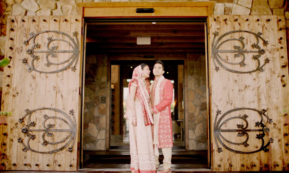 Indian wedding couple in front of Grand Cascades Lodge