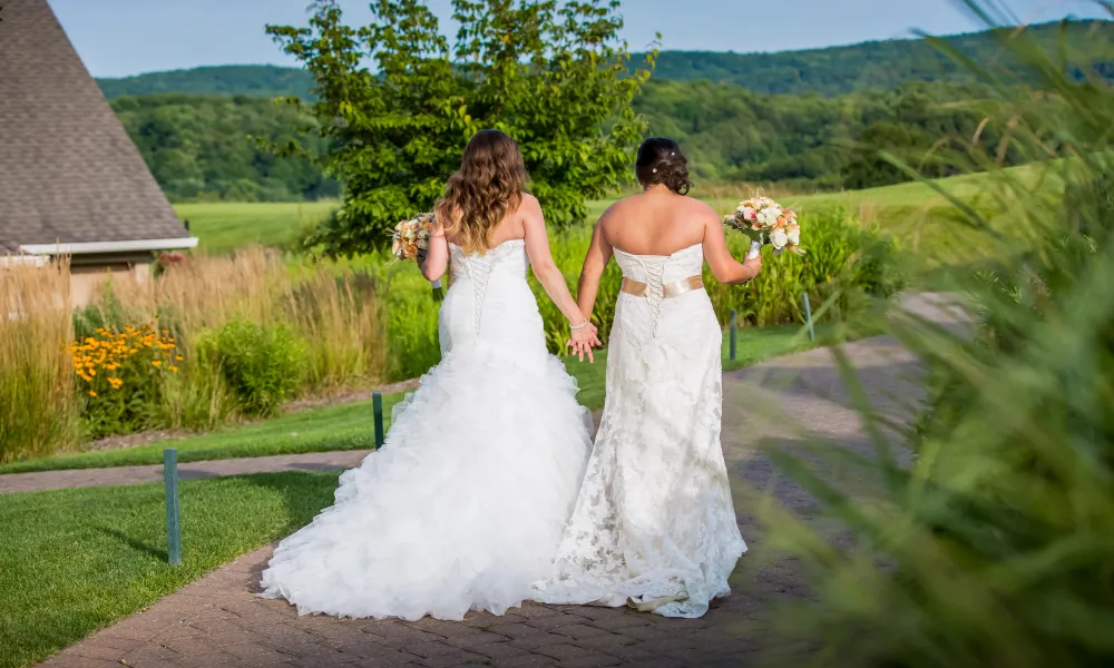 Brides holding hands walking away