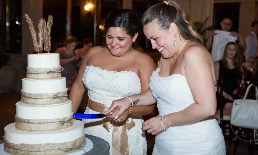 Brides cutting their wedding cake