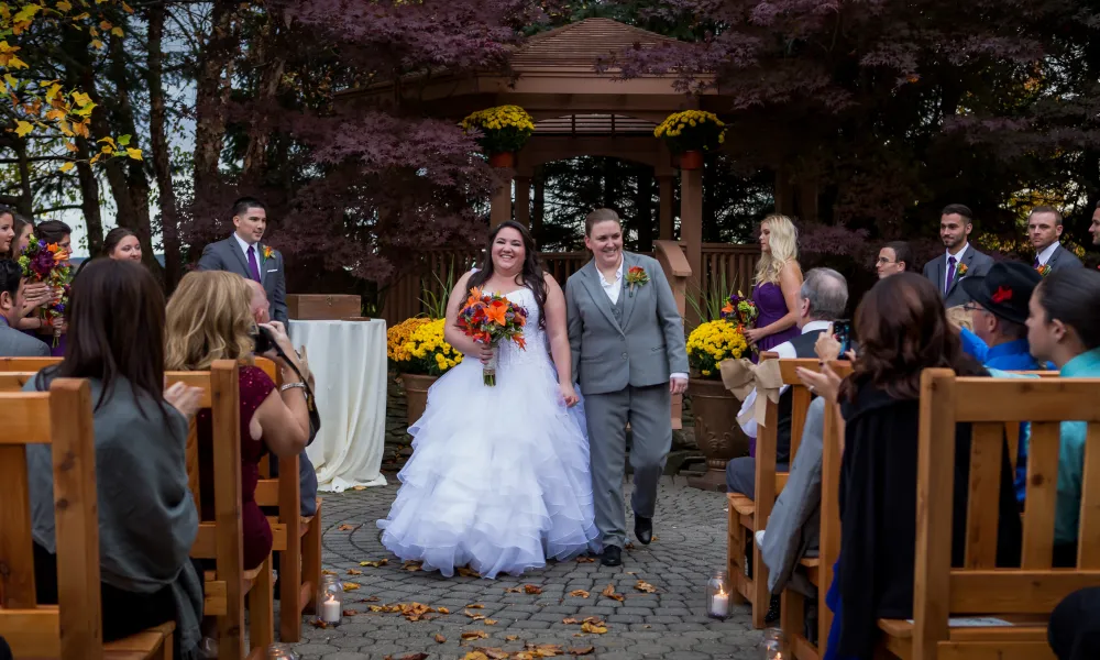 Brides at outdoor wedding ceremony at Black Bear Country Club