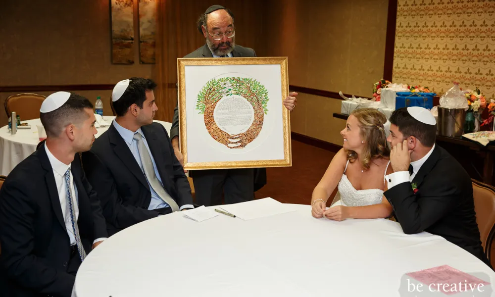 Man showing Ketubah at Jewish wedding