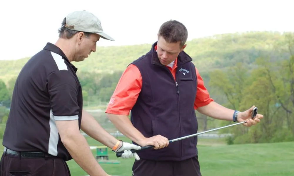 Golf Instructor teaching man to golf at Crystal Springs Resort