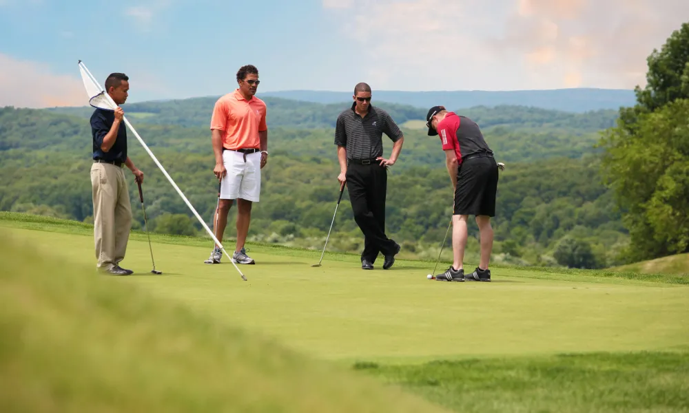 Foursome on the putting green at Wild Turkey golf course