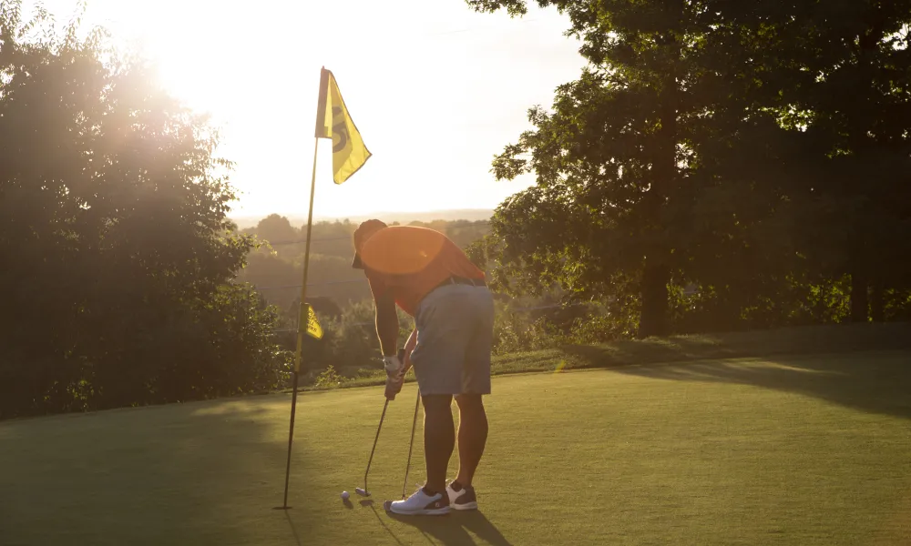 Man making his putt at a hole on Black Bear Golf Course