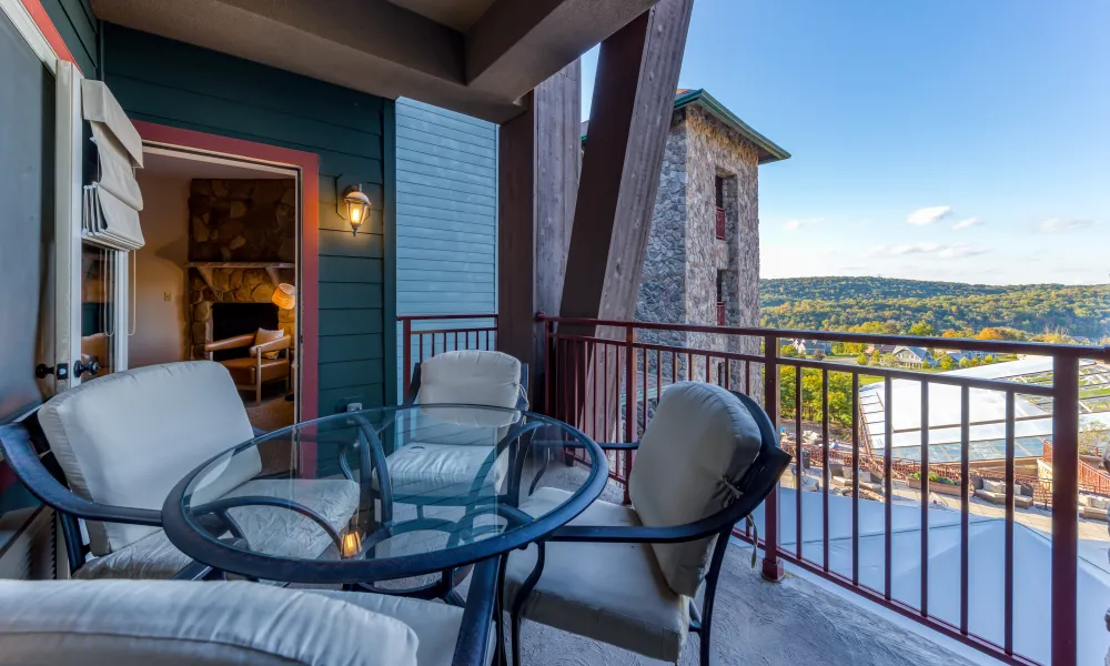 Table and chairs on balcony of Grand Cascades Lodge suite.