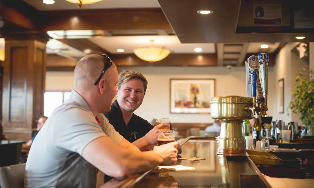 Men enjoying drinks at Crystal Tavern bar