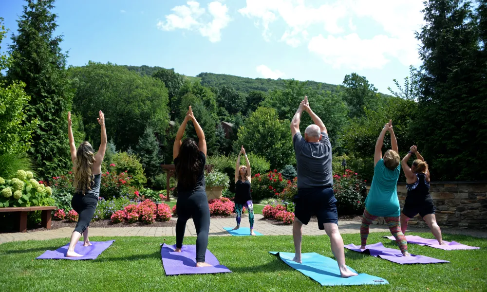  Outdoor Yoga Class surrounded by greenery