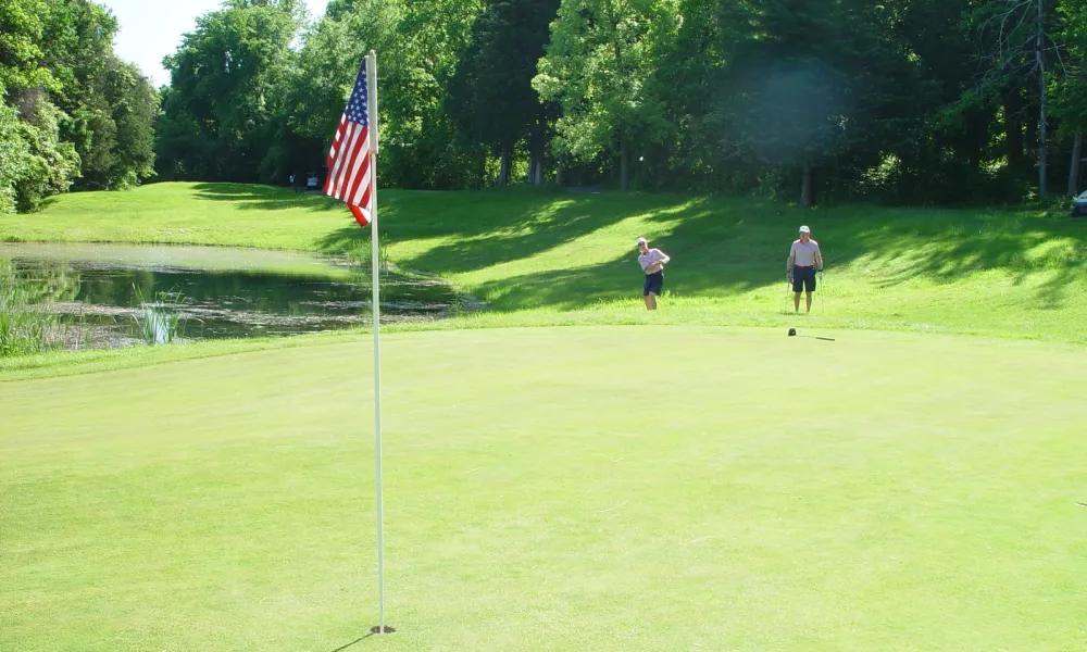 Two golfers on the green of  Minerals Golf Club at Crystal Springs Resort