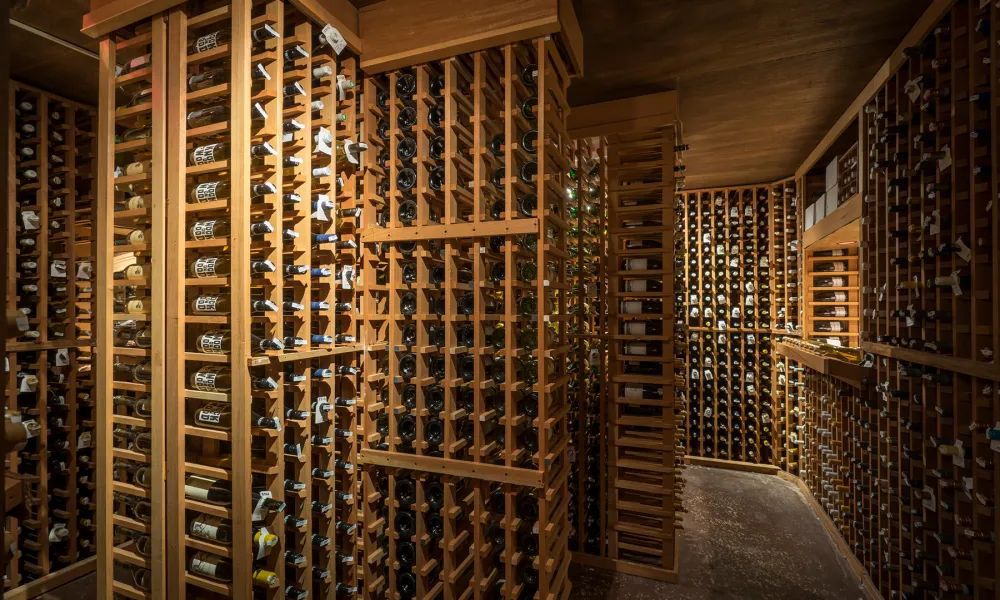 Tall wooden columns filled with wine for display.