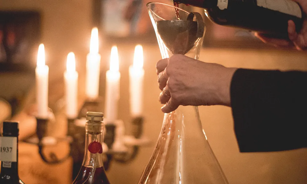 Susanne Wagner pouring wine into a decanter.