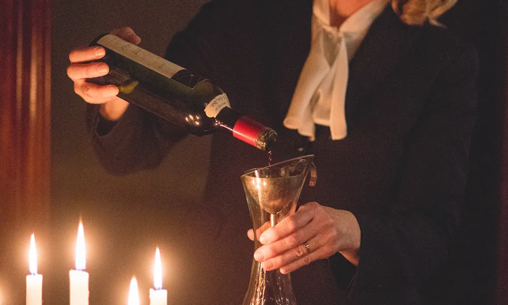 Susanne Wagner pouring wine into a decanter.