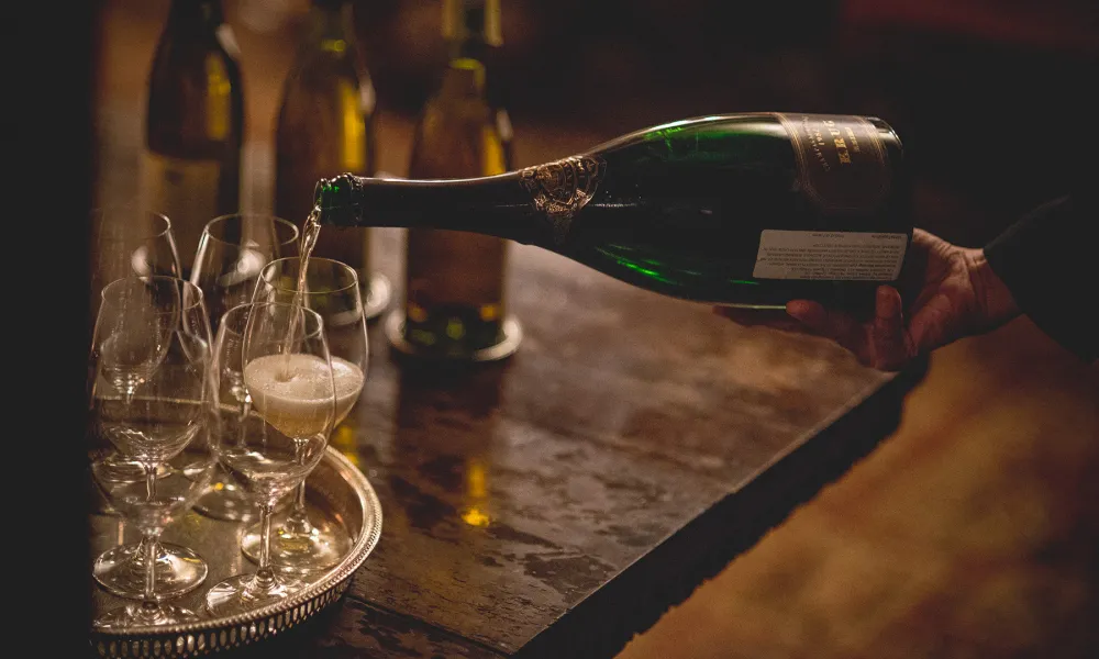 White wine being poured into glasses.