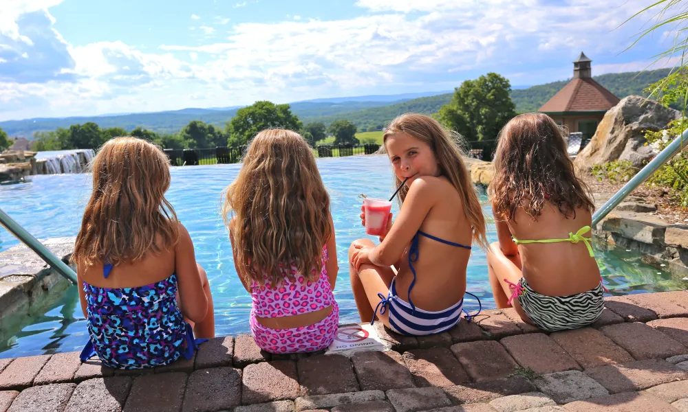 Kids sitting by the Vista 180 Pool