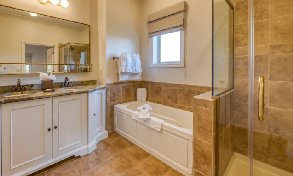 Hotel suite bathroom with shower, tub and large vanity