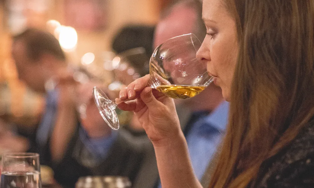 Woman drinking white wine.