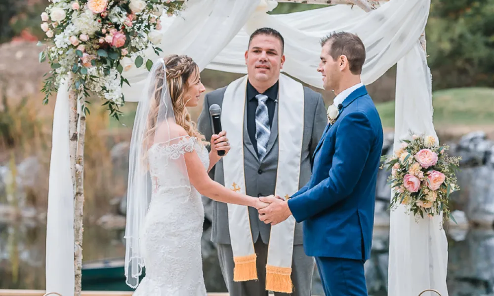 Romantic couple holding hands at the alter