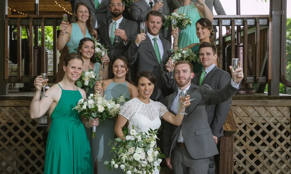 Wedding party making a toast on the stairs of Sweetgrass Pavillion