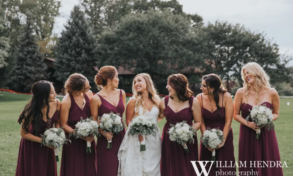 Bride smiling with bridesmaids 