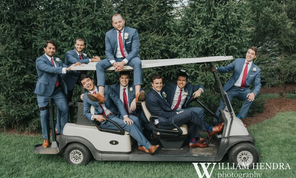 Groomsmen piled onto golf cart