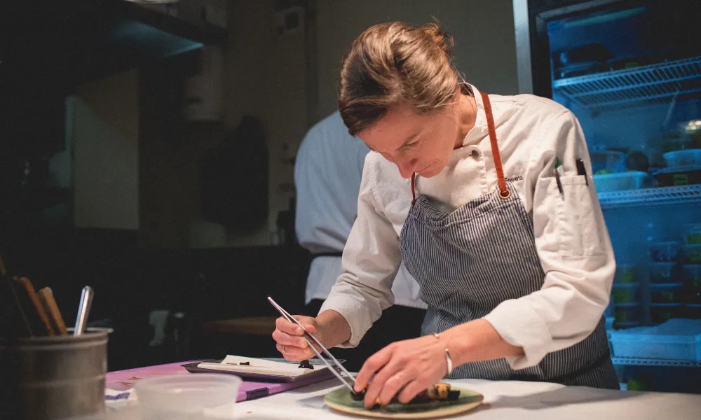 Chef Aishling Stevens plating a dish in Latour