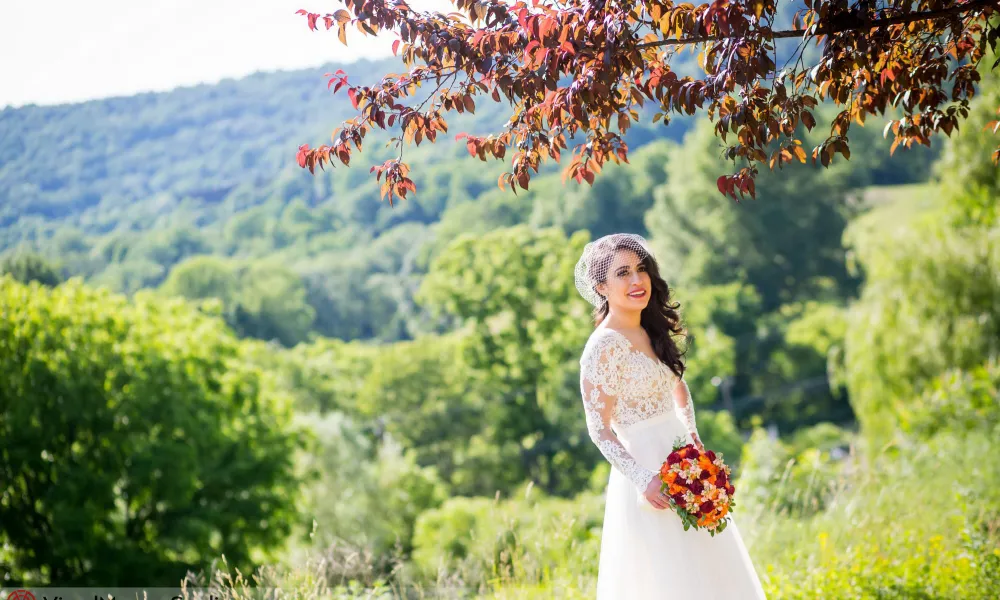 Bride smiling under autumn tree