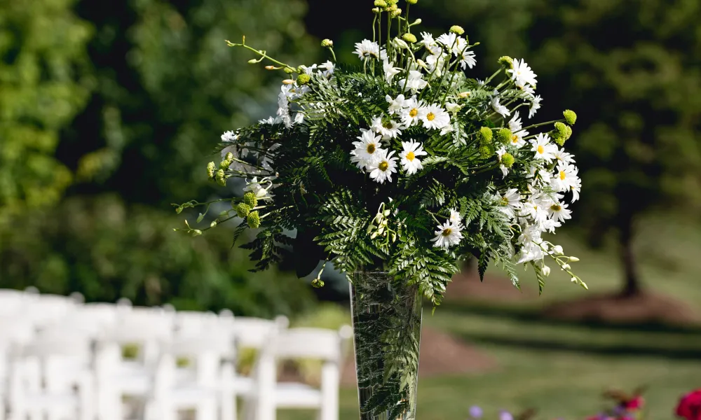 Bouquet of flowers with champagne glasses at wedding cocktail hour