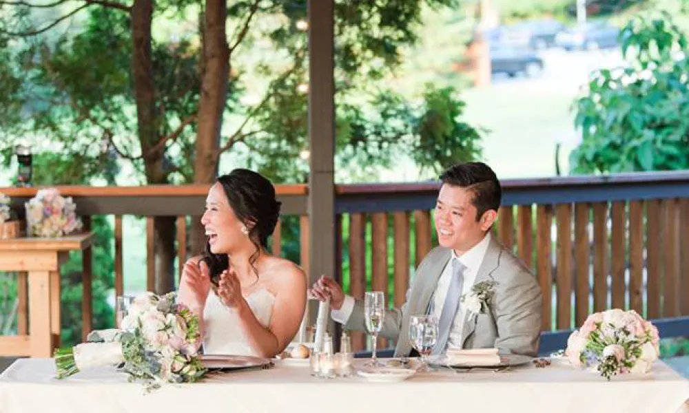 Wedding couple at sweetheart table at Sweetgrass Pavillion