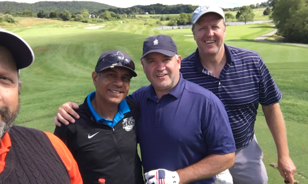 Guys having a good time on a golf course at Crystal Springs Resort