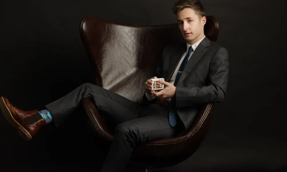 Man sitting in brown leather chair.