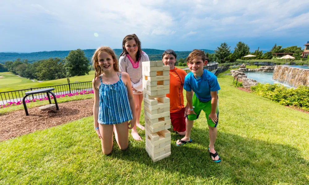 Kids playing lawn jenga.