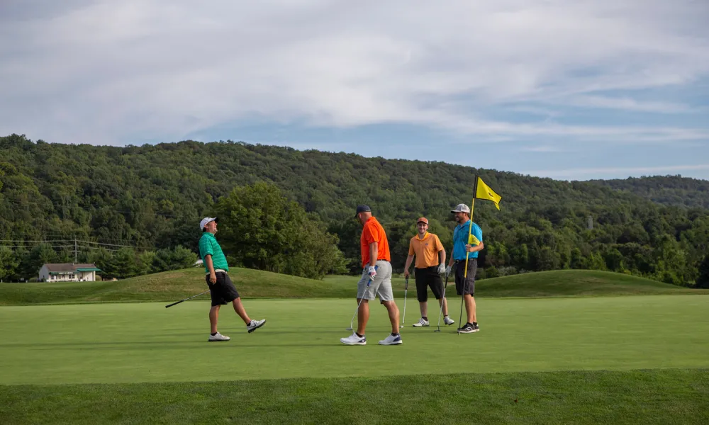 Foursome of guys on the green at Black Bear Golf Club