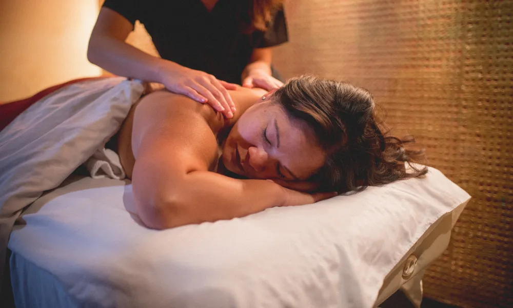 Woman getting her back massaged.