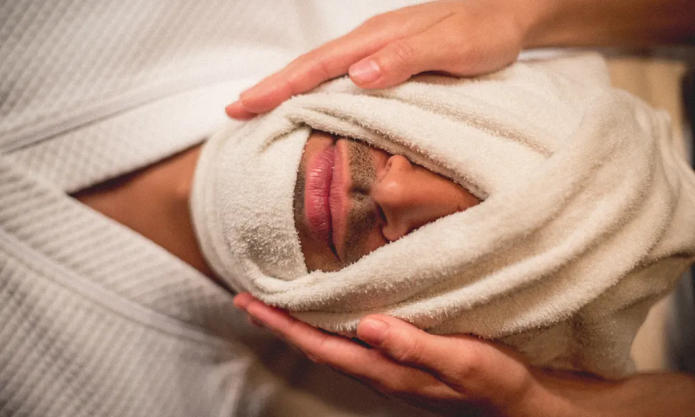 Towel wrapped around man's face