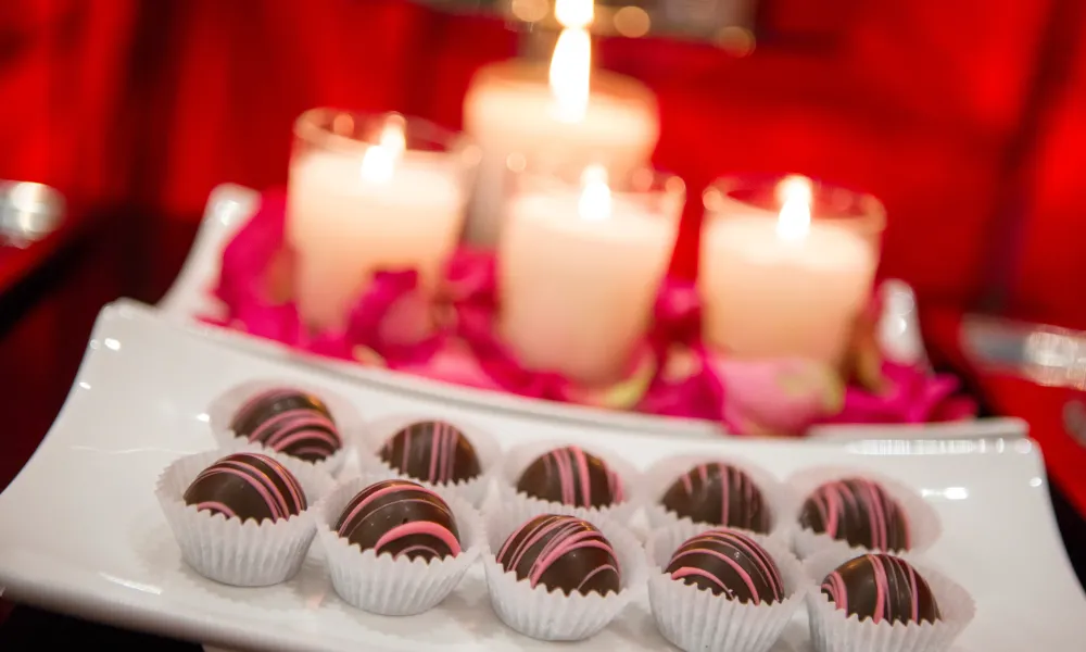 Chocolates with lit candles behind.