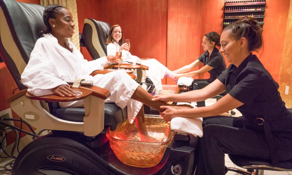 Two guests in white robes getting a pedicure at Reflection Spa in NJ.