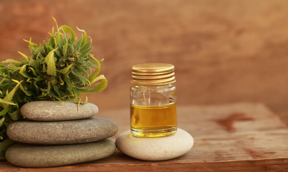 CBD oil in a jar on top of a rock.