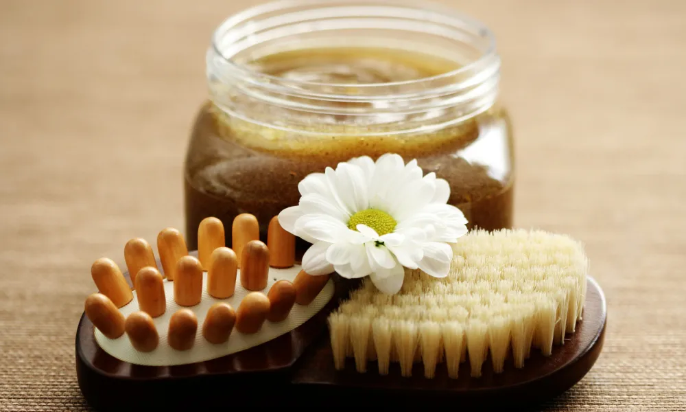 Body scrub container wth body scrub brush.