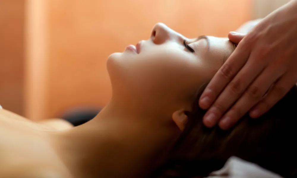 Woman receiving head massage.