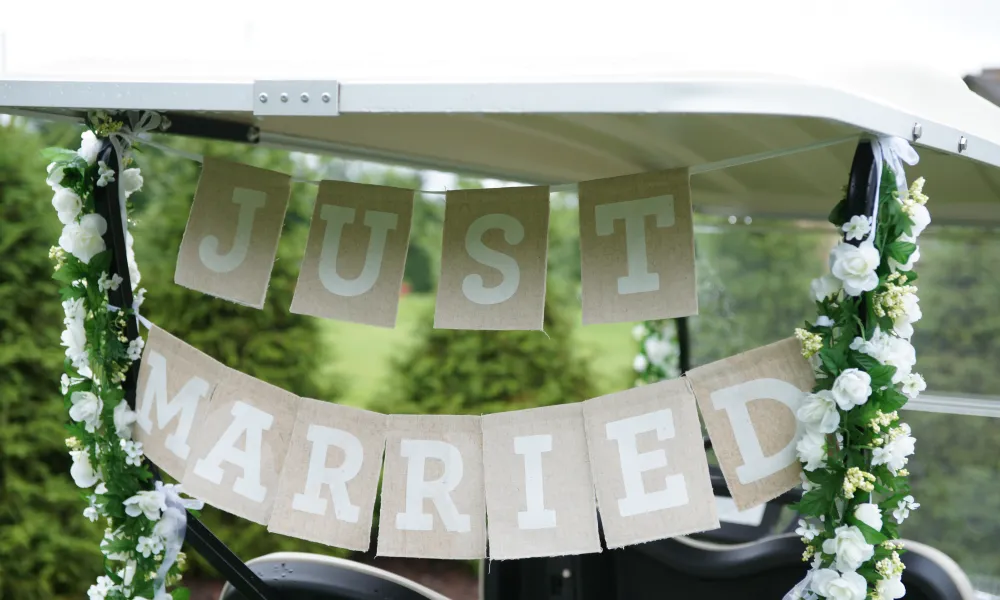 &quot;Just Married&quot; sign on the back of a golf care