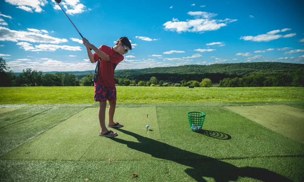 Boy golfing on the driving range at a resort close to NYC