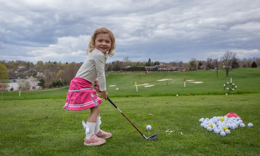 Young girl learning to golf at Crystal Springs Resort