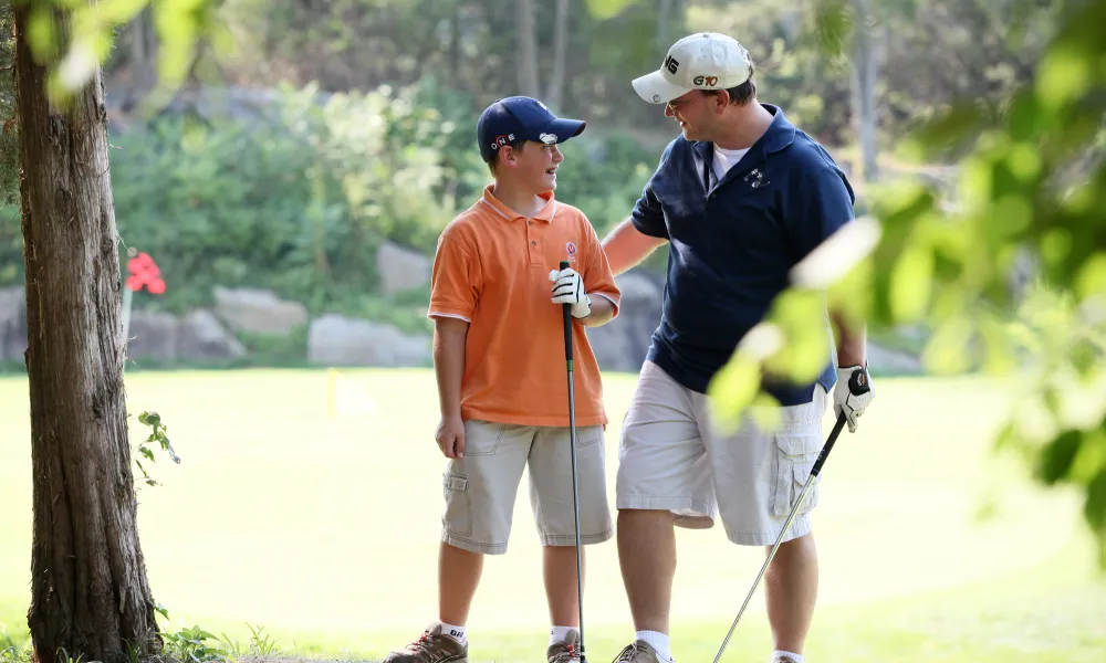 Father and son on a golf course at Crystal Springs Resort