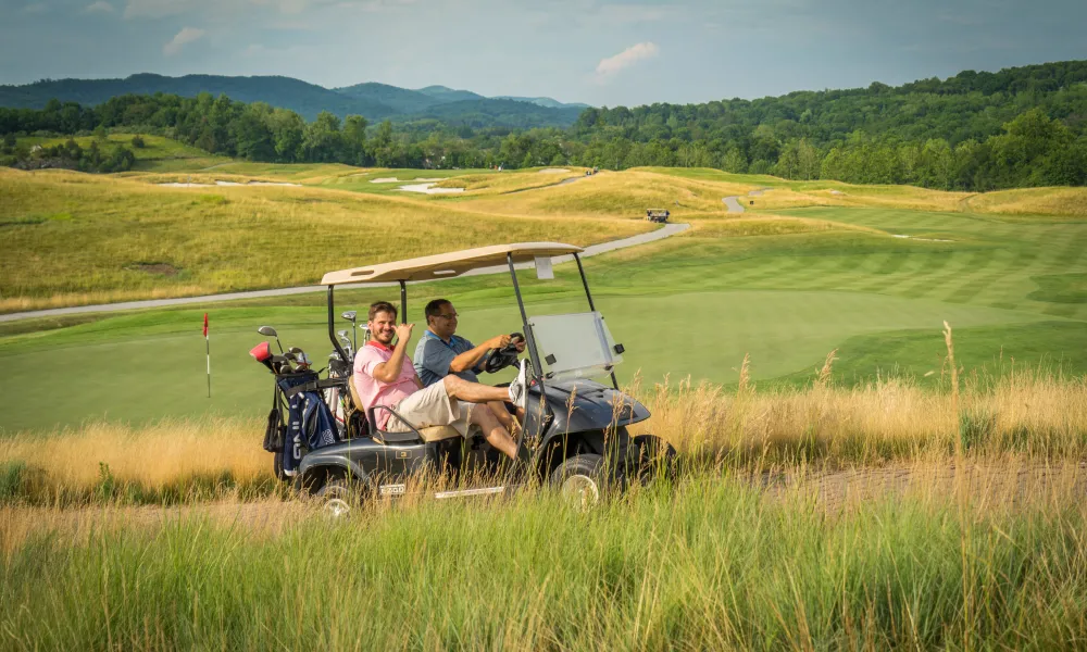 Guys riding on a golf cart at Ballyowen