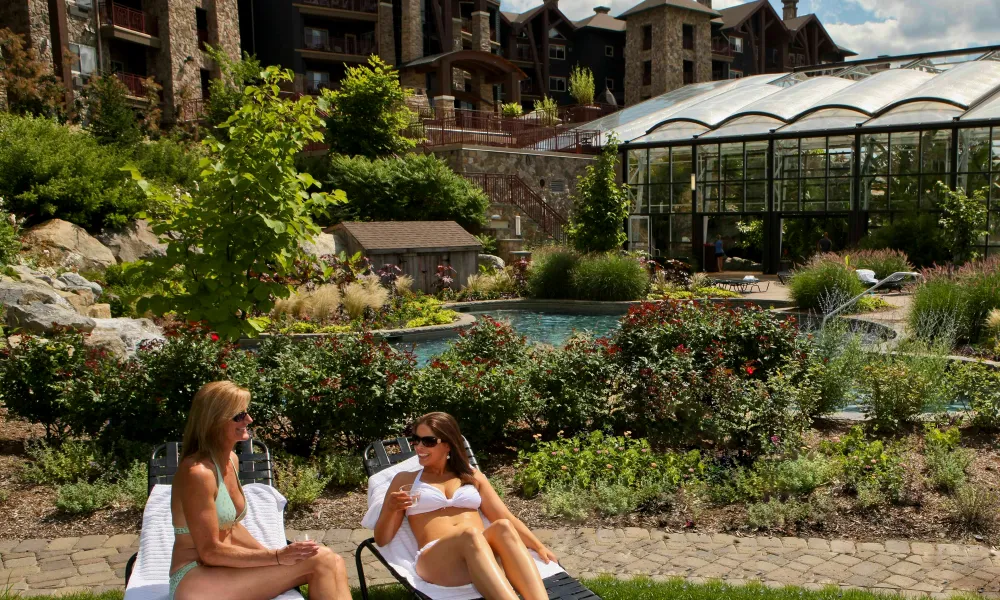 Two women sunbathing at Biosphere outdoor pool