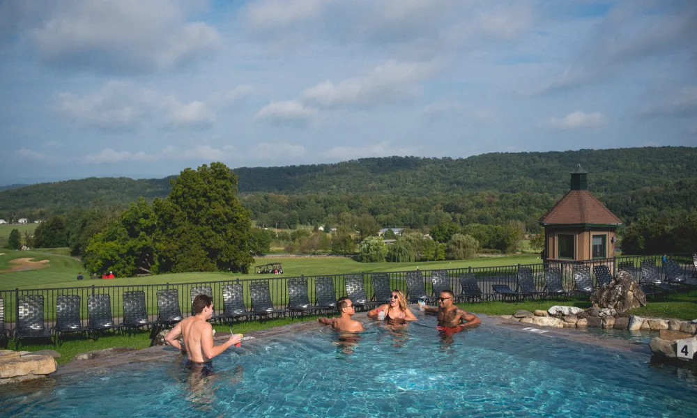 Group of friends relaxing in Vista 180 pool.