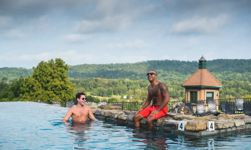 Two men relaxing in Vista 180 pool.