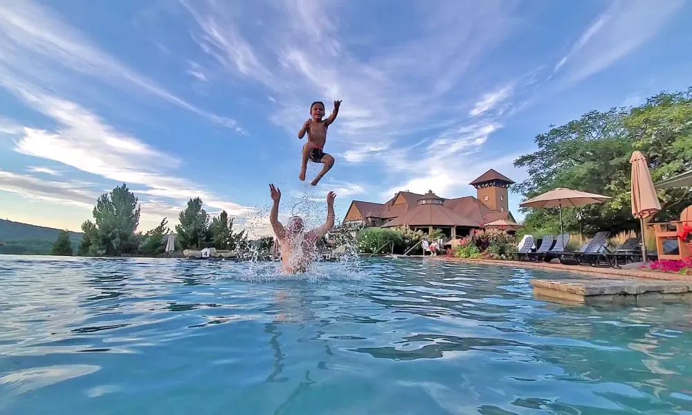 Man throwing child in air in vista 180 pool.