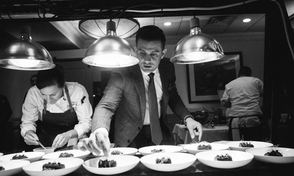 Robby Younes plating dinner