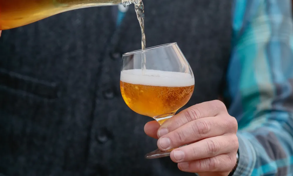 Pouring hard cider into a glass