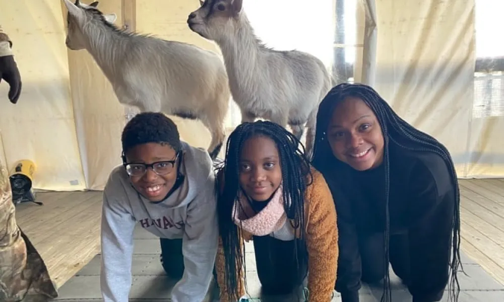 Group with goats on their backs